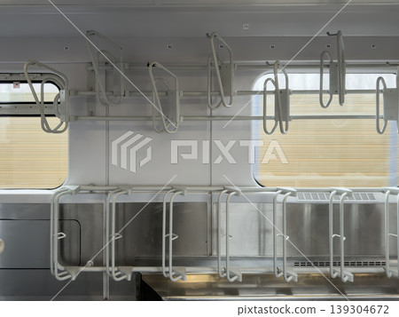 Modern train interior showcases empty bicycle racks above seats, emphasizing sustainable urban commuting and public transport infrastructure 139304672