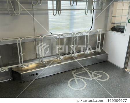 Modern public transport interior featuring dedicated bicycle rack system and clear floor marking indicating cyclist-friendly space, promoting multimodal commuting Modern public transport interior featuring dedicated bicycle rack system and clear floor marking indicating cyclist-friendly space, promoting multimodal commuting 139304677