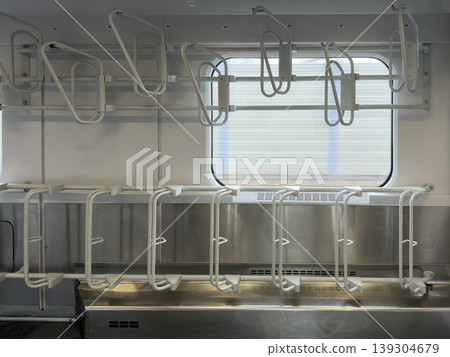 Empty white bicycle racks inside modern train carriage, facilitating commuter travel and sustainable transport solutions for passengers Empty white bicycle racks inside modern train carriage, facilitating commuter travel and sustainable transport solutions for passengers 139304679