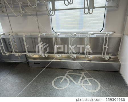 Modern train carriage interior showcases designated bicycle parking racks and floor marking symbol for commuters traveling with cycles Modern train carriage interior showcases designated bicycle parking racks and floor marking symbol for commuters traveling with cycles 139304680