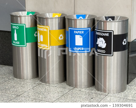 Four color-coded recycling bins for glass, plasticmetal, paper, and mixed waste promote environmental responsibility and urban sustainability Four color-coded recycling bins for glass, plasticmetal, paper, and mixed waste promote environmental responsibility and urban sustainability 139304691