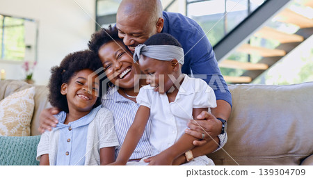 Happy family, children and hug on sofa in living room for bond, embrace and together. Black man, woman and girl with laugh for funny joke, story or memory with love, care and relationship in home Happy family, children and hug on sofa in living room for bond, embrace and together. Black man, woman and girl with laugh for funny joke, story or memory with love, care and relationship in home 139304709