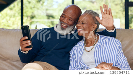Video call, happy senior couple and phone in home for voip communication, social network or chat. African man, woman or wave hello on smartphone in virtual conversation, contact or talk in retirement Video call, happy senior couple and phone in home for voip communication, social network or chat. African man, woman or wave hello on smartphone in virtual conversation, contact or talk in retirement 139304711