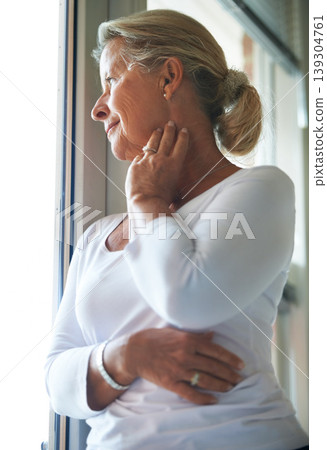 Senior, woman and thinking by window with memory, remember and happy in retirement for dementia in nursing home. Elderly, person or ideas with smile, mindfulness and reflection on past life with calm 139304761