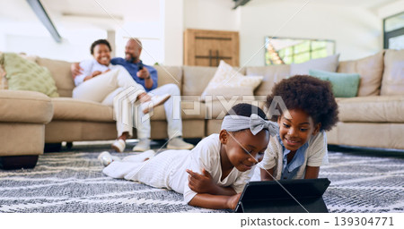 Family, children and tablet on floor watching cartoons, parents and living room couch. Screen time, relaxing and streaming while bonding together as siblings, technology and childhood memories Family, children and tablet on floor watching cartoons, parents and living room couch. Screen time, relaxing and streaming while bonding together as siblings, technology and childhood memories 139304771