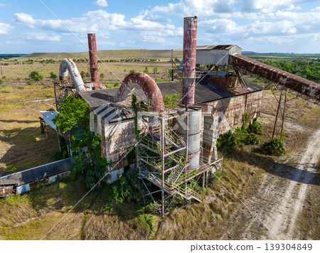 Industrial ruins of former phosphate mining plant in central Florida with old infrastructure and corroded metal structure. Industrial ruins of former phosphate mining plant in central Florida with old infrastructure and corroded metal structure. 139304849