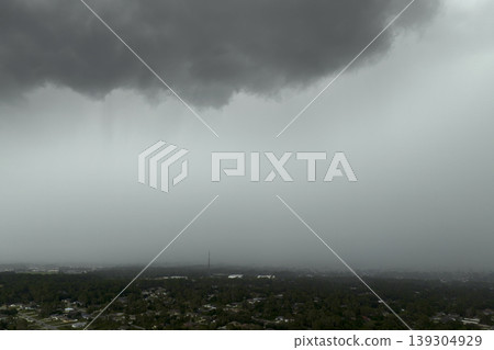 Heavy rain falling down from stormy clouds over rural Florida suburbs. Thunderstorm on dark sky. Moving and changing cloudscape weather Heavy rain falling down from stormy clouds over rural Florida suburbs. Thunderstorm on dark sky. Moving and changing cloudscape weather 139304929
