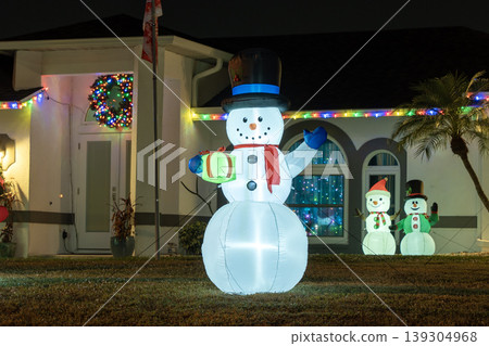 Front yard holiday decor with glowing Christmas lights. Festive Florida celebration in warm winter without snow. 139304968