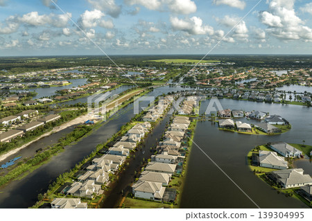Flooding in Florida caused by tropical storm from hurricane Debby. Suburb houses in residential community surrounded by flood waters in Sarasota. Aftermath of natural disaster 139304995