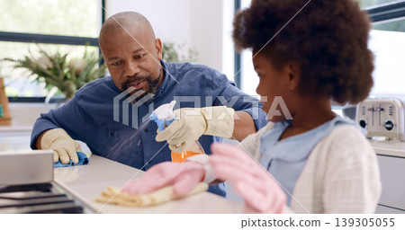 Kitchen counter, dad teaching or kid cleaning with teamwork, gloves or cloth to wipe off dirty table. Bacteria, child or girl learning to help father on messy surface in a family home with spray Kitchen counter, dad teaching or kid cleaning with teamwork, gloves or cloth to wipe off dirty table. Bacteria, child or girl learning to help father on messy surface in a family home with spray 139305055