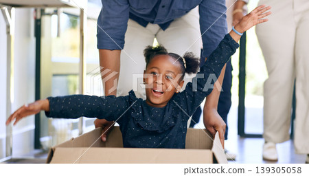 Playing, black man in new home, child in box and smile at front door with property mortgage. Moving, father and game with daughter in house, excited for investment, real estate and future together. Playing, black man in new home, child in box and smile at front door with property mortgage. Moving, father and game with daughter in house, excited for investment, real estate and future together. 139305058