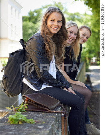 School, friends and portrait of sitting on a wall, outdoor on campus with women and happiness. Social, students and smile for learning, education and studying at academy with backpack in morning School, friends and portrait of sitting on a wall, outdoor on campus with women and happiness. Social, students and smile for learning, education and studying at academy with backpack in morning 139305059
