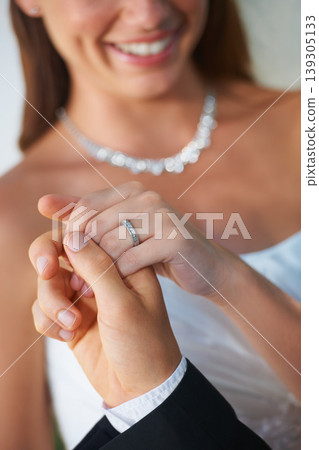 Couple, wedding ring and hands together in marriage with bride and smile at celebration and trust event. Flower, loyalty and care with romance and jewelry with love and commitment with woman and man Couple, wedding ring and hands together in marriage with bride and smile at celebration and trust event. Flower, loyalty and care with romance and jewelry with love and commitment with woman and man 139305133