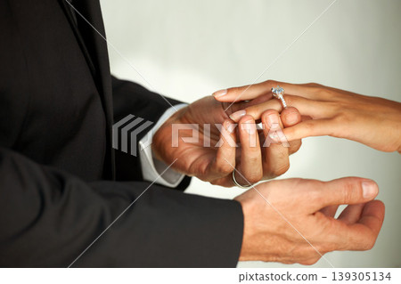 Couple, bride and ring on hand, commitment and love at wedding, promise and loyalty in marriage. Newlyweds, jewelry and faith or trust in relationship, hope and partnership in closeup of support Couple, bride and ring on hand, commitment and love at wedding, promise and loyalty in marriage. Newlyweds, jewelry and faith or trust in relationship, hope and partnership in closeup of support 139305134