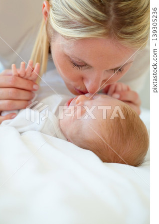 Closeup, mom and baby with kiss on bed for love, care and bonding in relationship. Infant, sleep or dreaming of hope, future or new life with growth, milestone or child development in family home Closeup, mom and baby with kiss on bed for love, care and bonding in relationship. Infant, sleep or dreaming of hope, future or new life with growth, milestone or child development in family home 139305236