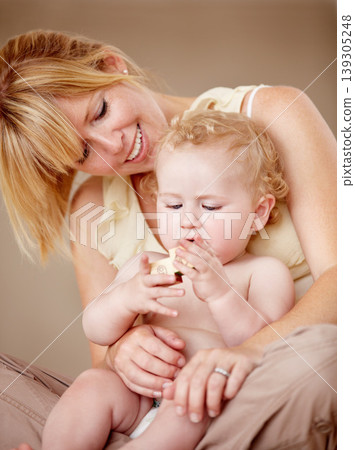 Hug, love and mother with baby for playing, games or bonding in their home together. Family, face and parent embrace boy child in a living room having fun with building blocks, toys or learning Hug, love and mother with baby for playing, games or bonding in their home together. Family, face and parent embrace boy child in a living room having fun with building blocks, toys or learning 139305248
