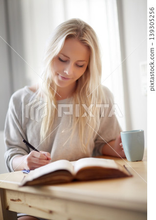 Coffee, relax and woman writing in a book at home for idea, planning or creative, research or diary. Notebook, education and female student in a house with tea while brainstorming homework assignment Coffee, relax and woman writing in a book at home for idea, planning or creative, research or diary. Notebook, education and female student in a house with tea while brainstorming homework assignment 139305256
