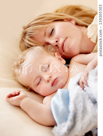 Sleeping, mom and baby with peace in bed together with calm moment with love for infant and kid in morning nap. Mother, cuddle and sleep with child in closeup and rest in bedroom or family home Sleeping, mom and baby with peace in bed together with calm moment with love for infant and kid in morning nap. Mother, cuddle and sleep with child in closeup and rest in bedroom or family home 139305303