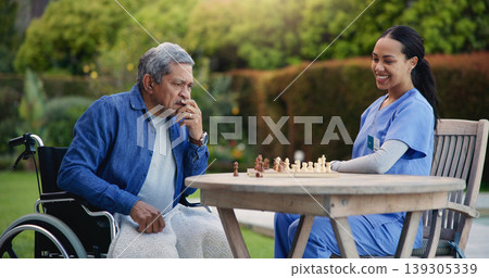 Happy woman, nurse and senior playing chess in nature for elderly care, match or thinking in strategic game. Female, medical caregiver or person with a disability contemplating next move on board Happy woman, nurse and senior playing chess in nature for elderly care, match or thinking in strategic game. Female, medical caregiver or person with a disability contemplating next move on board 139305339