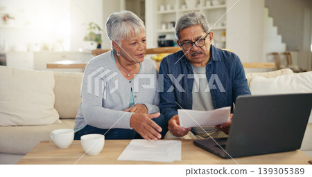 Elderly, couple and documents for financial planning in home with laptop, internet and reading for account balance. Senior man, woman and discussion with tech, webpage or online banking for budget Elderly, couple and documents for financial planning in home with laptop, internet and reading for account balance. Senior man, woman and discussion with tech, webpage or online banking for budget 139305389