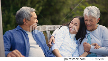 Senior, parents and woman in garden with hug, support and love in backyard and retirement. Happy family, elderly father and mother embrace daughter on bench in summer, park or bonding on vacation Senior, parents and woman in garden with hug, support and love in backyard and retirement. Happy family, elderly father and mother embrace daughter on bench in summer, park or bonding on vacation 139305485