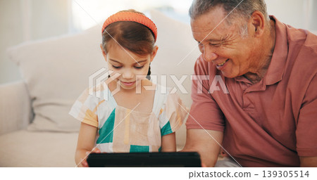 Home, grandfather and girl with tablet, smile and relax with social media, online gaming and digital app. Apartment, elderly man and pensioner with grandchild, tech and happiness with fun or network 139305514