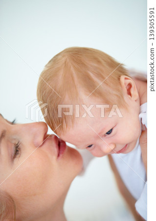 Mother, forehead and kiss baby with love for relax, care support and health wellness with parent happiness. Woman, holding and newborn with blonde hair, gratitude and security trust of maternal bond Mother, forehead and kiss baby with love for relax, care support and health wellness with parent happiness. Woman, holding and newborn with blonde hair, gratitude and security trust of maternal bond 139305591