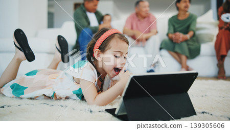 Girl child, happy and tablet on floor in family home for movie, streaming subscription and relax in living room. Kid, digital touchscreen and smile on carpet with cartoon, video or learning in house 139305606