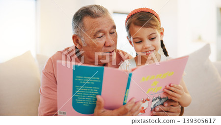 Grandfather, child and reading book on sofa for literature, education or bonding together at home. Grandparent with little girl or kid smile for story, learning or relax on living room couch at house Grandfather, child and reading book on sofa for literature, education or bonding together at home. Grandparent with little girl or kid smile for story, learning or relax on living room couch at house 139305617