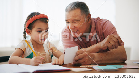 Child, senior man and learning or reading, book and education at home, drawing and support or paper. Girl, grandfather and notebook or tutoring, assessment and smile for language or math homework Child, senior man and learning or reading, book and education at home, drawing and support or paper. Girl, grandfather and notebook or tutoring, assessment and smile for language or math homework 139305635