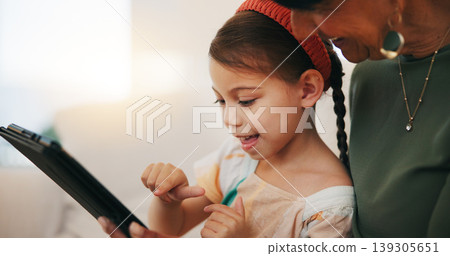 Home, grandmother and girl with tablet, happy and relax with social media, online gaming and digital app. Apartment, senior woman or pensioner with grandchild, tech or fun with connection or internet Home, grandmother and girl with tablet, happy and relax with social media, online gaming and digital app. Apartment, senior woman or pensioner with grandchild, tech or fun with connection or internet 139305651