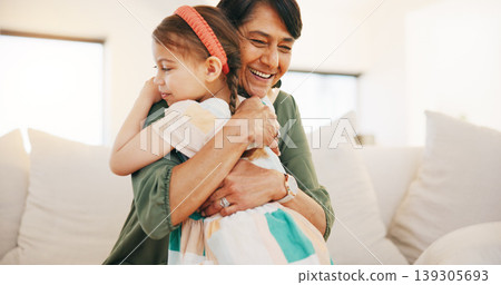 Grandmother, child and hug on sofa in living room for love, care and bond for relationship. Senior woman, little girl and smile in happiness for memory, moment or support while babysitting at home Grandmother, child and hug on sofa in living room for love, care and bond for relationship. Senior woman, little girl and smile in happiness for memory, moment or support while babysitting at home 139305693
