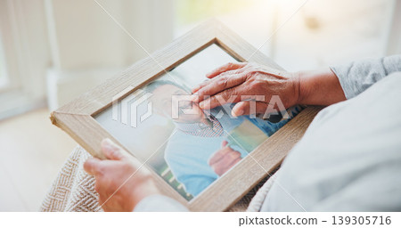 Senior woman, grief and picture of husband on lap, hands and sad of love loss in retirement. Elderly person, alone and dear memory of beloved with anxiety, mental health and lonely bereaved in house 139305716