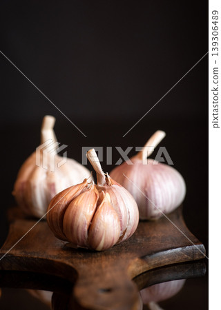 Fresh Garlic Bulbs on Wooden Cutting Board Fresh Garlic Bulbs on Wooden Cutting Board 139306489