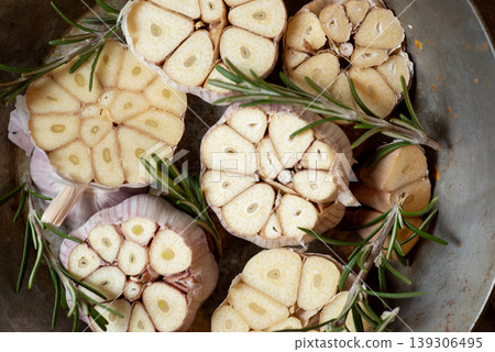Fresh Garlic Bulbs with Rosemary Sprigs in a Metal Bowl Fresh Garlic Bulbs with Rosemary Sprigs in a Metal Bowl 139306495