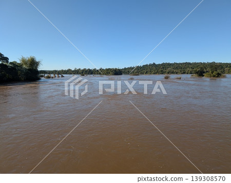 A view of the full-flowing Iguazu River and coastline in Iguazu National Park and Reserve in Argentina in June A view of the full-flowing Iguazu River and coastline in Iguazu National Park and Reserve in Argentina in June 139308570