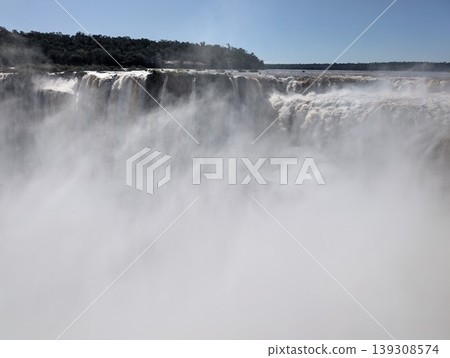 Iguazu Falls in a mist of spray at Iguazu National Park and Reserve in Argentina in June. Close-up Iguazu Falls in a mist of spray at Iguazu National Park and Reserve in Argentina in June. Close-up 139308574