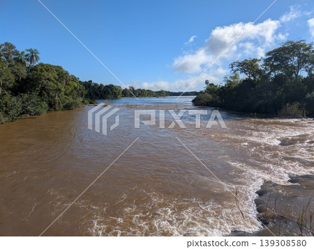 A view of the rapids and rushing waters of the Iguazu River in Iguazu National Park and Reserve in Argentina A view of the rapids and rushing waters of the Iguazu River in Iguazu National Park and Reserve in Argentina 139308580