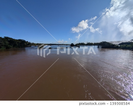 A view of the full-flowing Iguazu River and unique vegetation in the sun's rays at Iguazu National Park and Reserve in Argentina in June 139308584
