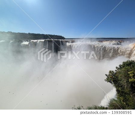 The turbulent waters of Iguazu Falls in the sun's rays at Iguazu National Park and Reserve in Argentina in June 139308591
