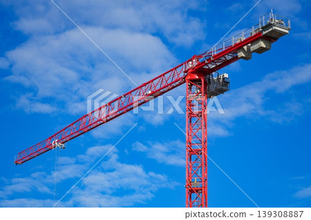 Construction crane boom with hanging hook against sky. Construction crane boom with hanging hook against sky. 139308887