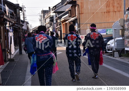 Men participating in the Inuyama Spring Festival in Inuyama City, Aichi Prefecture, walking through the castle town wearing traditional happi coats and brightly colored obi sashes. Men participating in the Inuyama Spring Festival in Inuyama City, Aichi Prefecture, walking through the castle town wearing traditional happi coats and brightly colored obi sashes. 139308999