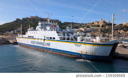 A small ferry moored at the port of Gozo 139309089