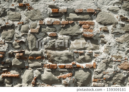 Old stone and brick wall texture highlighting traditional building technique and a naturally textured architectural background. 139309181