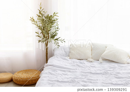 Bright minimal Scandinavian bedroom interior with white bedding and decorative pillows Bright minimal Scandinavian bedroom interior with white bedding and decorative pillows 139309291
