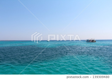 Tropical Ocean with Boats Under a Clear Sky Tropical Ocean with Boats Under a Clear Sky 139309480