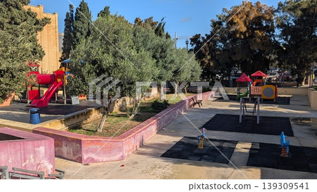 Playground with trees in the city in Gozo Playground with trees in the city in Gozo 139309541