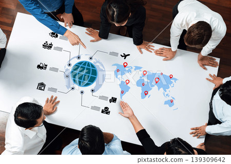 Collaborative Team Discussion Around Global Logistics and Supply Chain Strategy with Mapping and Icons on a Table Ledger Collaborative Team Discussion Around Global Logistics and Supply Chain Strategy with Mapping and Icons on a Table Ledger 139309642