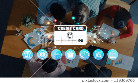 Group of Diverse Professionals Collaborating on Financial Strategies with Digital Credit Card Graphic Overlaid on Meeting Table Quark Group of Diverse Professionals Collaborating on Financial Strategies with Digital Credit Card Graphic Overlaid on Meeting Table Quark 139309706