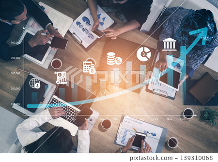 Business Meeting with Financial Data Analysis and Growth Graph Displayed on a Table in an Office Setting Ledger 139310068